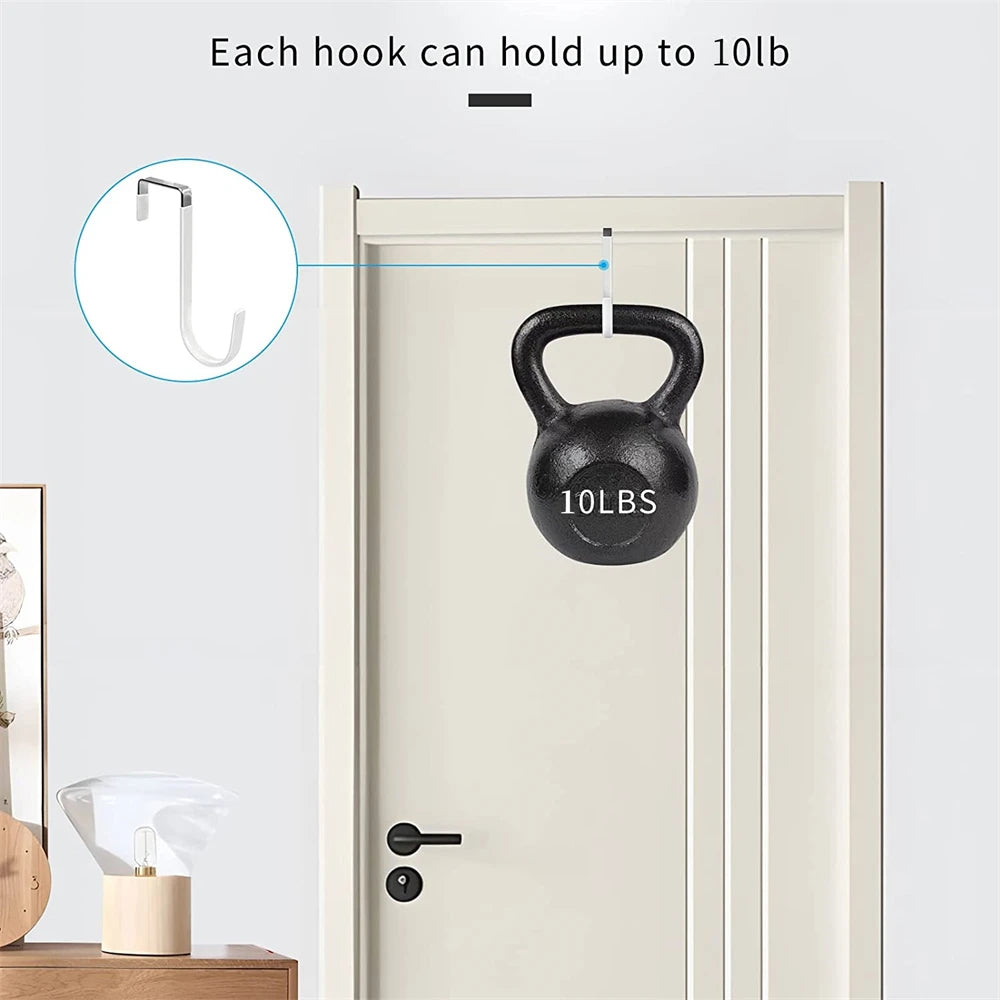 A black dumbbell shaped over-the-door hook is shown hanging on a white door, demonstrating its 10lb capacity.