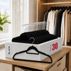A box of black velvet non-slip hangers with 360 degree rotating hooks displayed on a wooden surface.