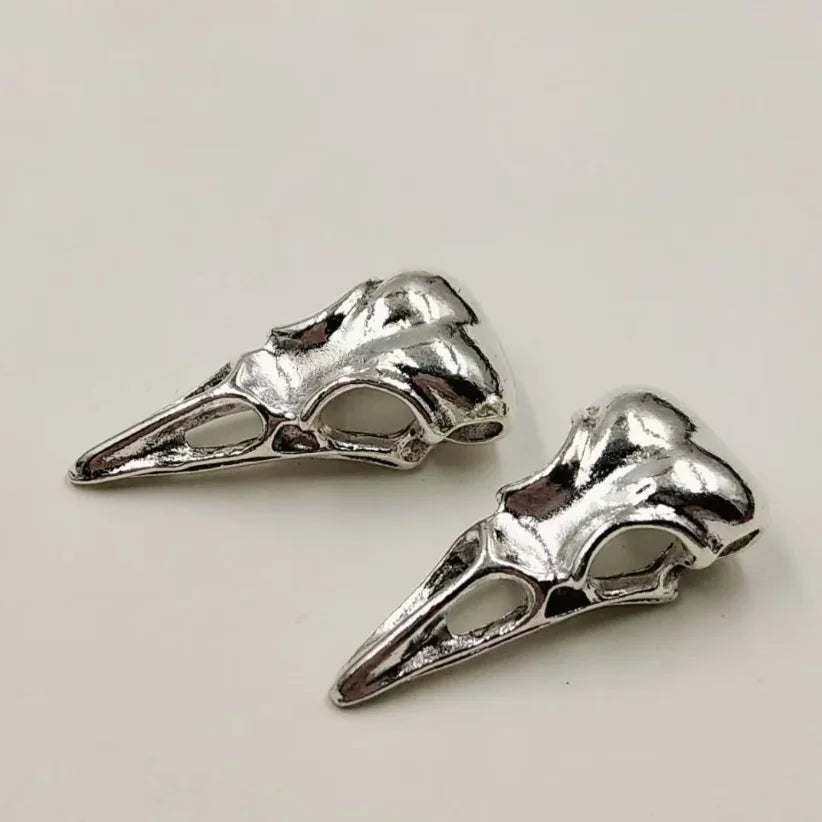 A set of five silver gothic skull and crow head charms for jewelry making