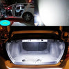 Interior view of a car with the door open, showing an LED light upgrade kit installed in the trunk area.