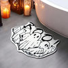 A black and white line art rug featuring multiple ghost designs and spider webs.