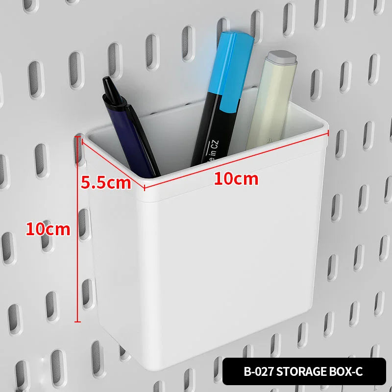 A white storage box with a lid is shown on a pegboard, containing three pens and a pencil.