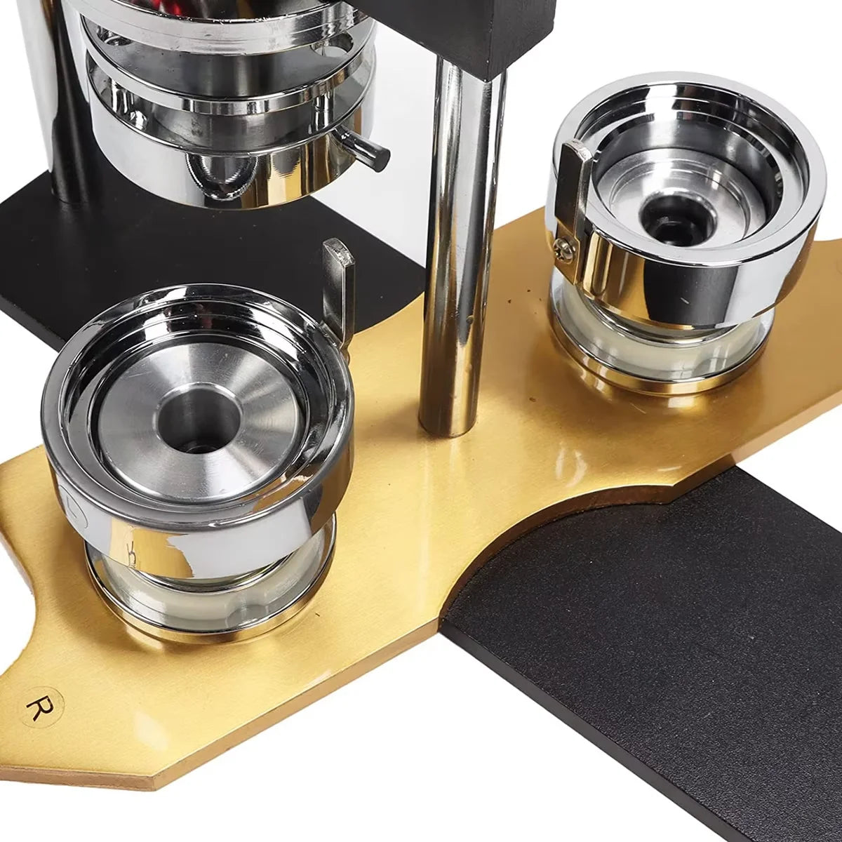 A close-up view of a button maker machine kit with various metal cutters and molds on a wooden base.