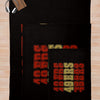 A black knit throw blanket featuring the 49ers team logo in red and gold colors.