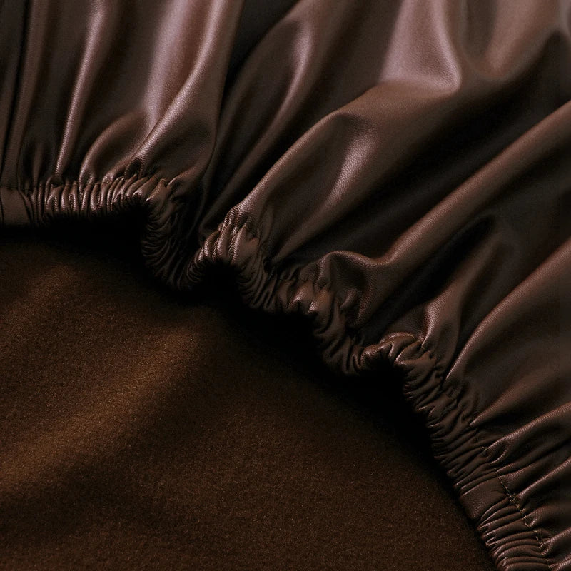 Close-up of a dark brown waterproof PU stretch bench cover with an elastic edge.