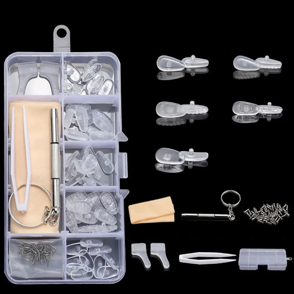 A clear plastic kit containing various tools and components for repairing glasses, including nose pads, screws, and precision
