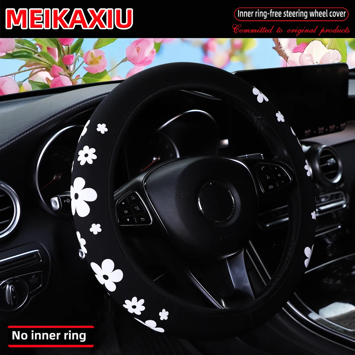 Black steering wheel cover with white floral pattern installed in a car interior.