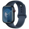 A dark blue silicone sport band for an Apple Watch shown on a wrist.