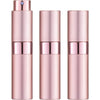 Un set de tres atomizadores de perfume de vidrio rosa en diseño cilíndrico.