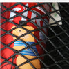 A close-up of a red container with an orange bear toy visible through a black elastic mesh storage bag.