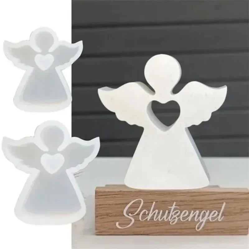 White angel-shaped silicone molds for resin and crafting displayed on a wooden base.
