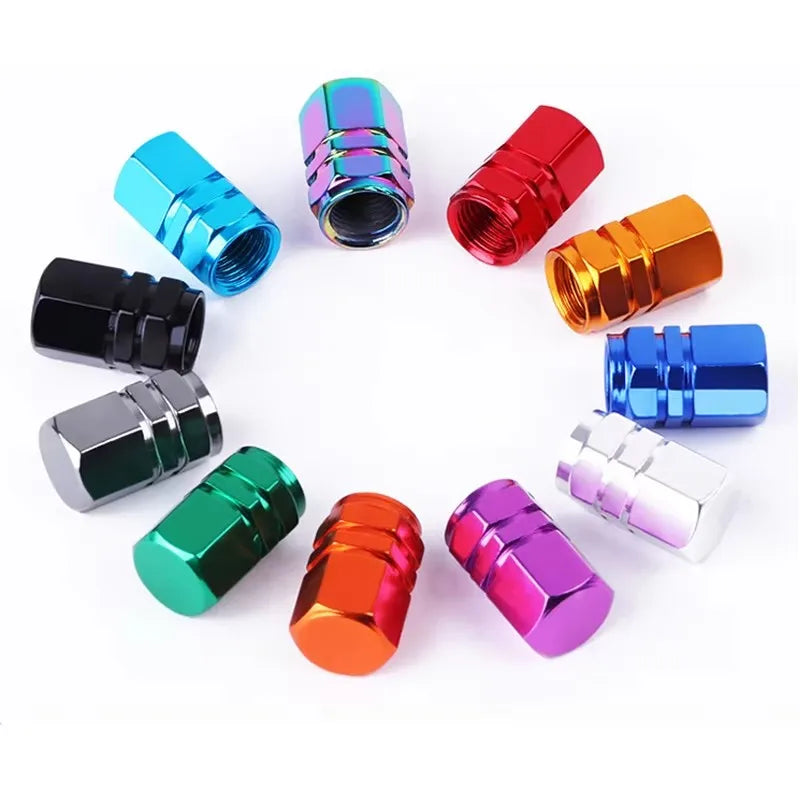A set of four colorful aluminum alloy wheel tire valve caps in various finishes, including blue, purple, red, and gold.