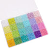 A plastic box filled with various colors of glass rice beads for jewelry making