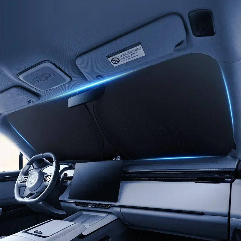 Interior view of a car showing a foldable windshield sunshade with blue LED lighting.