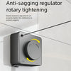 A close-up of an anti-sagging rotary tightening mechanism for a clothesline, showing a black device mounted on a white wall.