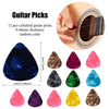 A collection of 12 guitar picks in various colors and finishes shown next to an acoustic guitar body.