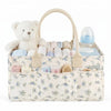 A beige floral diaper organizer bag featuring a teddy bear and multiple compartments for baby supplies.