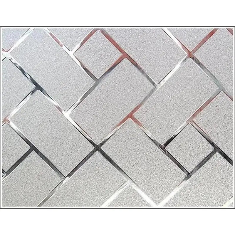 Decorative frosted window privacy film featuring a geometric diamond pattern with a silver and rose gold tint.