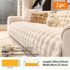 A beige plush anti-slip sofa cushion cover displayed on a sofa with decorative pillows.
