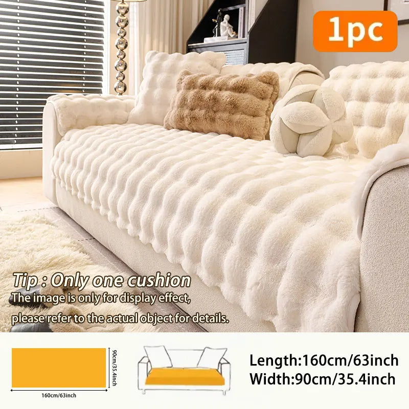 A beige plush anti-slip sofa cushion cover displayed on a sofa with decorative pillows.