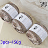 Three skeins of glitter yarn labeled MuYuan Frost Words are displayed on a light surface.