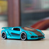 A bright turquoise 1:64 scale alloy sports car model with black accents, shown on a light surface.