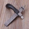 A close-up of an adjustable leather strap cutter with a black handle and silver blades resting on a wooden surface.
