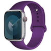 A purple silicone sport band worn around an Apple Watch.