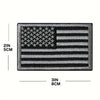 A rectangular patch featuring an embroidered American flag design with stars and stripes in black and gray.