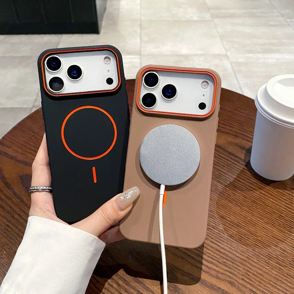 A hand holds a matte phone case with MagSafe support, featuring a black and orange design on a wooden surface.