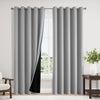 Gray insulated blackout curtain panels with grommet tops hanging in a window frame.