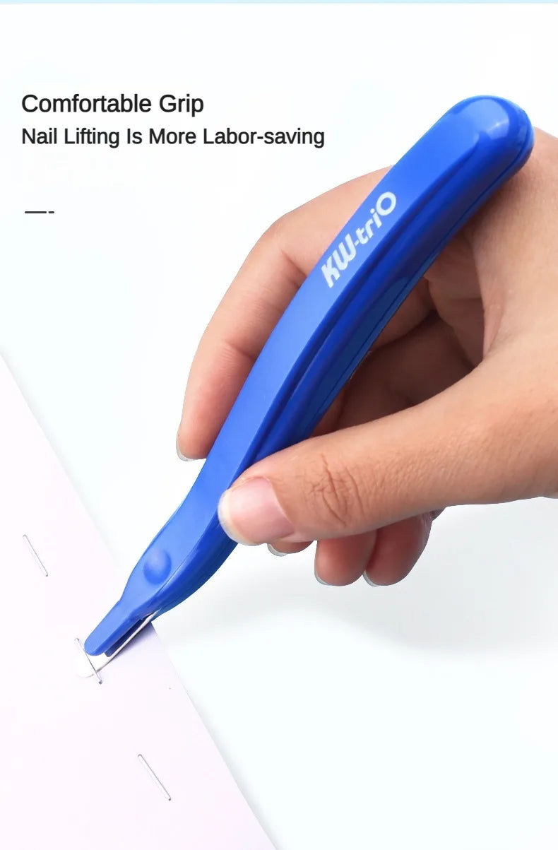 A hand holds a blue magnetic staple remover pen with an ergonomic grip, demonstrating its use.
