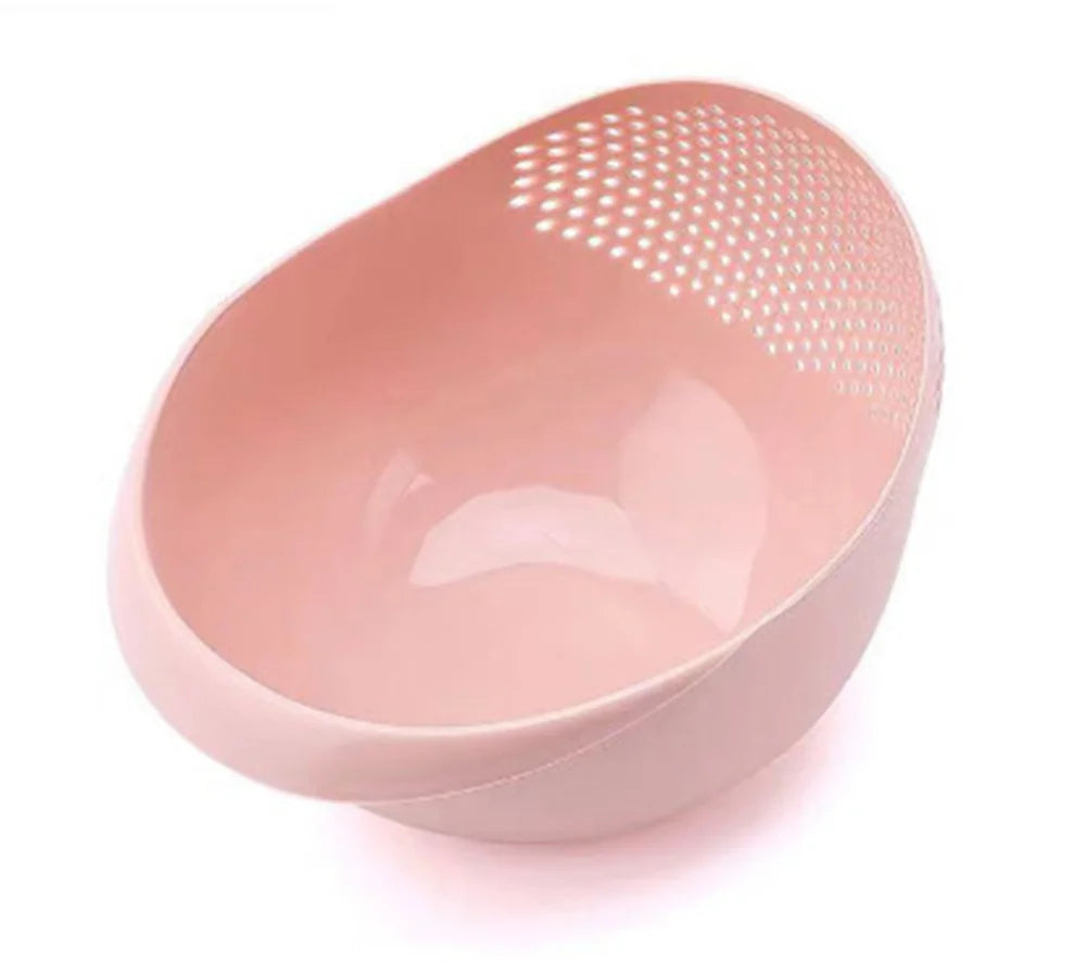A pink multi-purpose kitchen wash basket with a perforated design.
