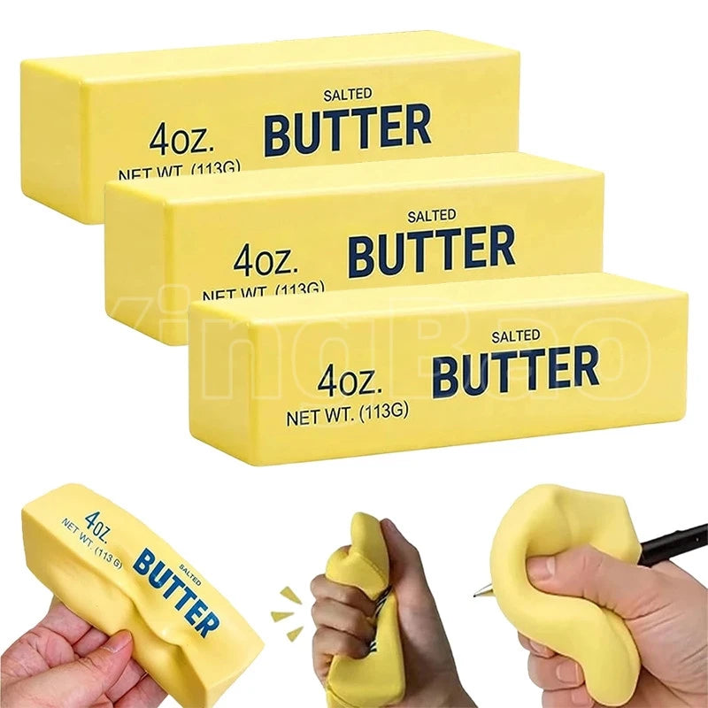 Three yellow butter fidget toys in boxes and a hand squeezing one