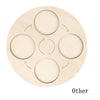 A light wooden board with five circular cutouts arranged in a cross pattern for a life cycle learning model.