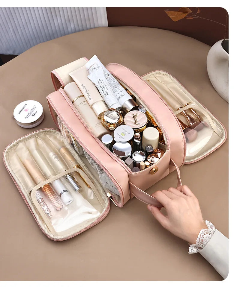 A pink waterproof PU leather cosmetic bag is open, displaying various makeup and skincare products.
