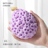 A hand holds a purple bath ball cheese made of soft mesh for baby