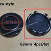 A set of four black hub caps for a Nissan wheel, shown in two views.