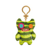 A green and yellow striped plush toy shaped like a monster with large orange and pink eyes and visible teeth, attached to a b