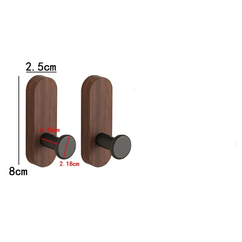 A pair of dark brown walnut wood hooks with round black mounting plates and a 2.5cm length.