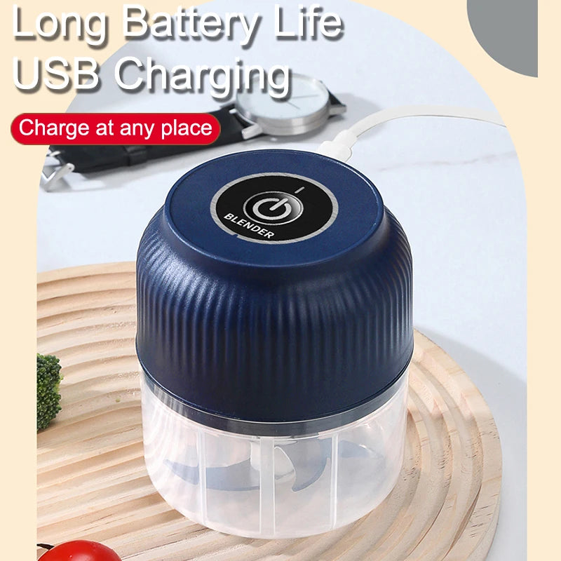 A blue mini electric blender jar with a clear lid is shown on a wooden cutting board, next to a USB charging cable.