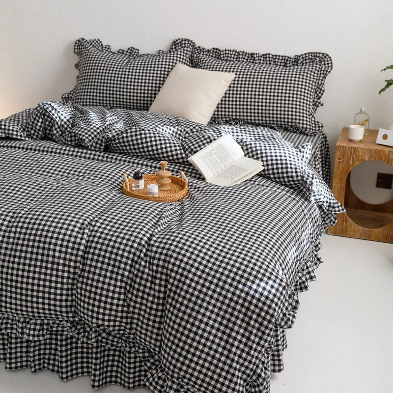 A plaid duvet cover set in black and white checks with matching pillowcases on a bed.