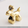 Gold-colored ceramic elephant and rabbit jewelry holder with a smooth, shiny finish.