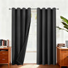 Blackout curtains hanging on a rod in a window frame