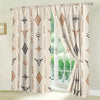 Light beige curtains featuring a boho tribal bull skull pattern and geometric designs filtering natural light.