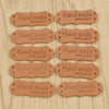 A collection of brown PU leather hand made with love sewing labels for handmade crafts.