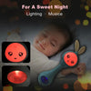 A baby is holding a glowing electronic rabbit rattle and teether toy for a sweet night.