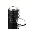 A black metal coin tube keychain with a silver cap and ring attached.