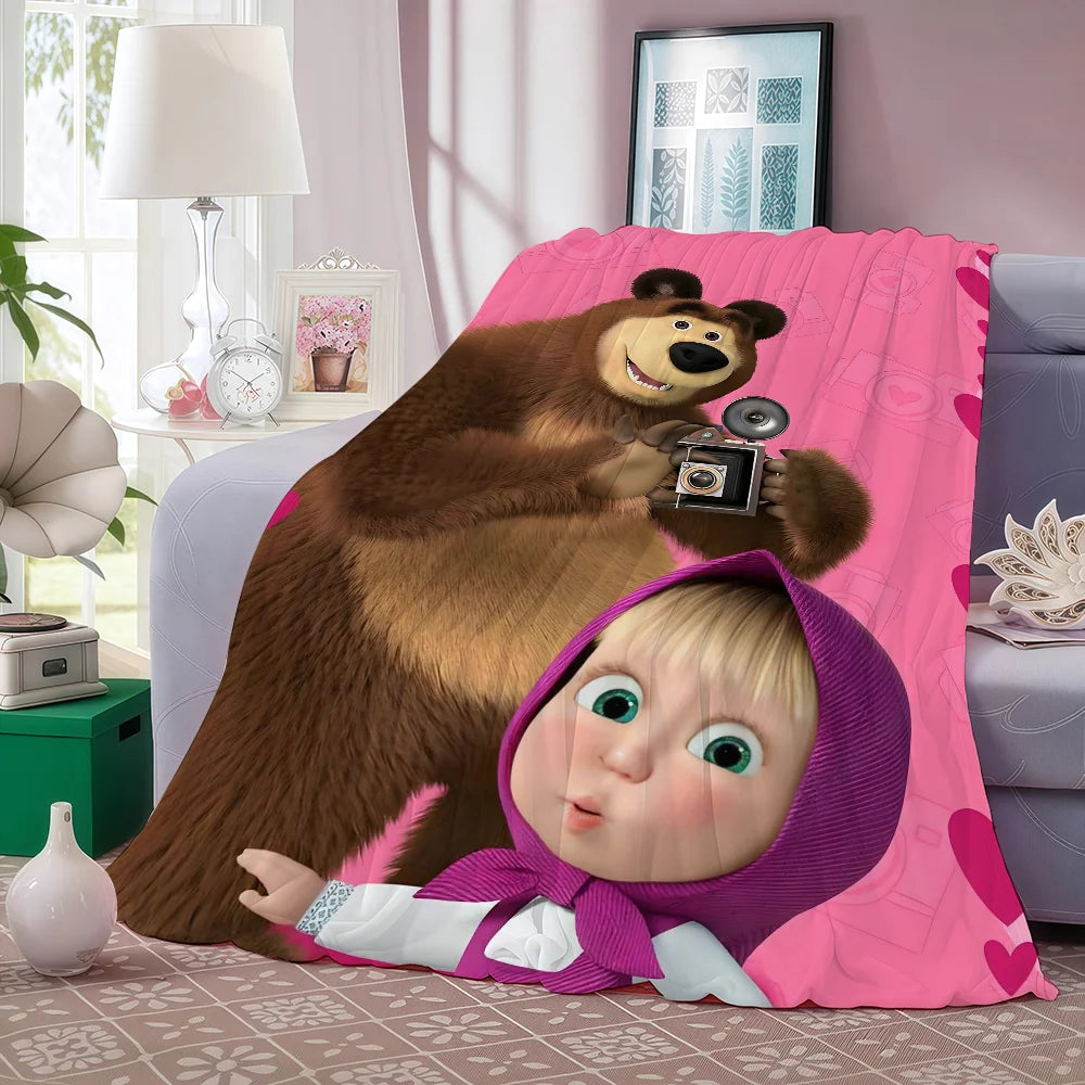 A plush bear and a baby character are featured on a pink fleece throw blanket.