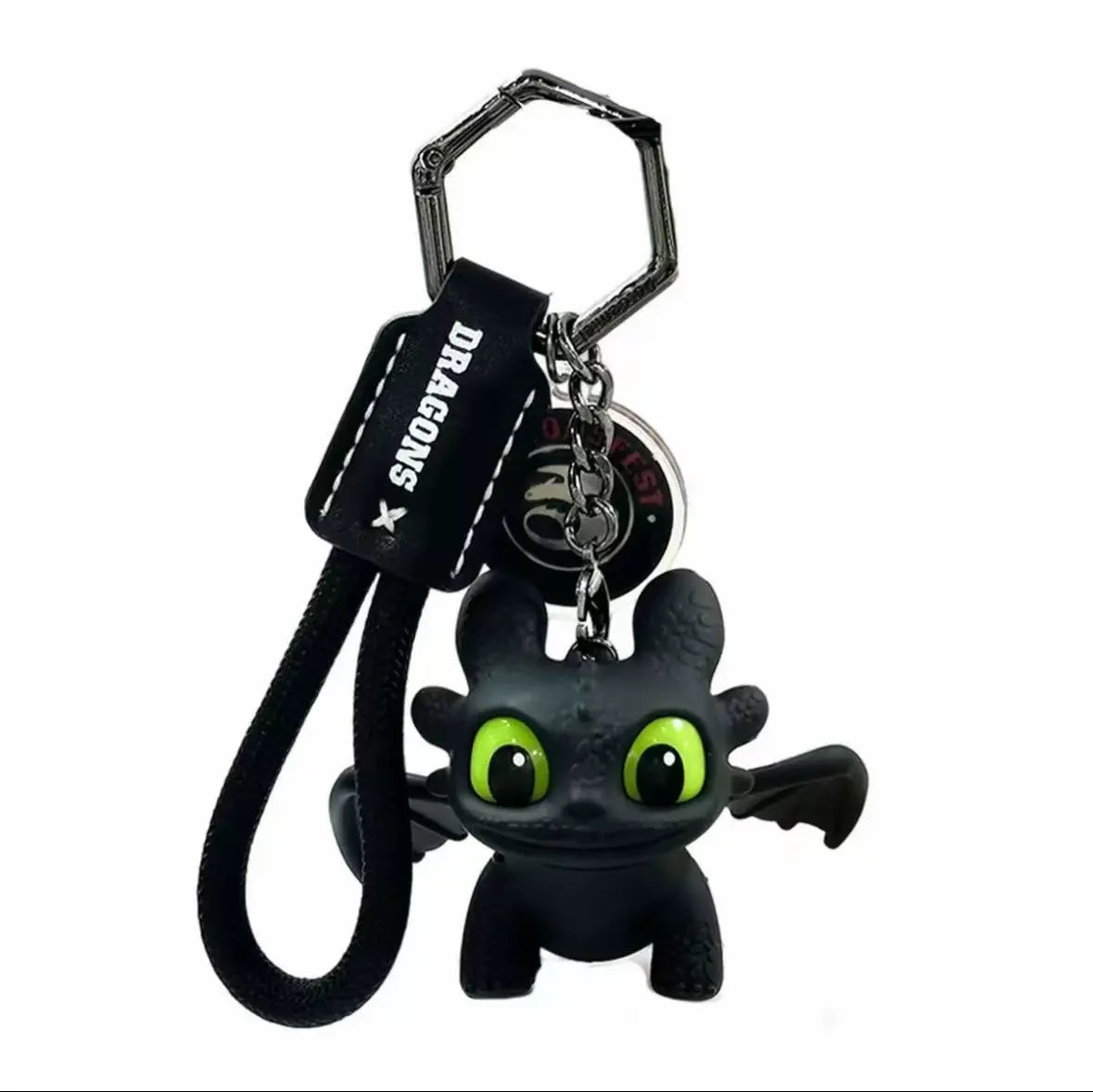 A black Toothless character ornament with glowing green eyes and movable wings attached to a key ring.